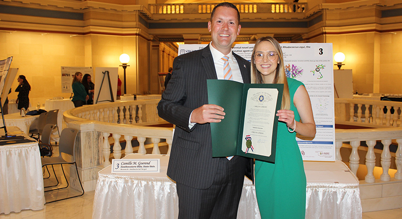 SWOSU student Camille M. Goerend of Weatherford won the overall grand prize at the recent 27th annual Oklahoma Research Day at the Capitol. Goerend becomes SWOSU’s fourth grand prize winner since the inception of the Oklahoma Research Day at the Capitol event. Congratulating her is Oklahoma House of Representative Anthony Moore of Clinton.